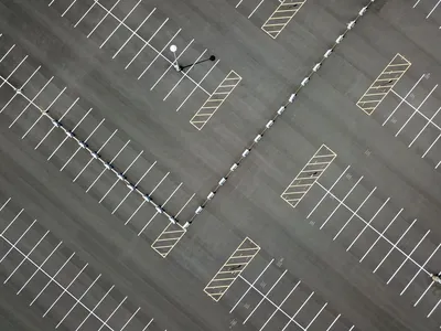 An aerial view of a vast, empty parking lot in Maplewood, MN, showcasing patterns and lines.